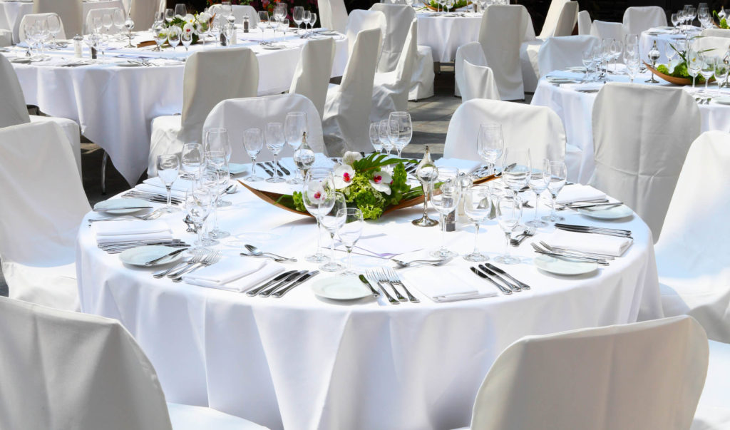 Linen company's white tablecloths and chair covers.